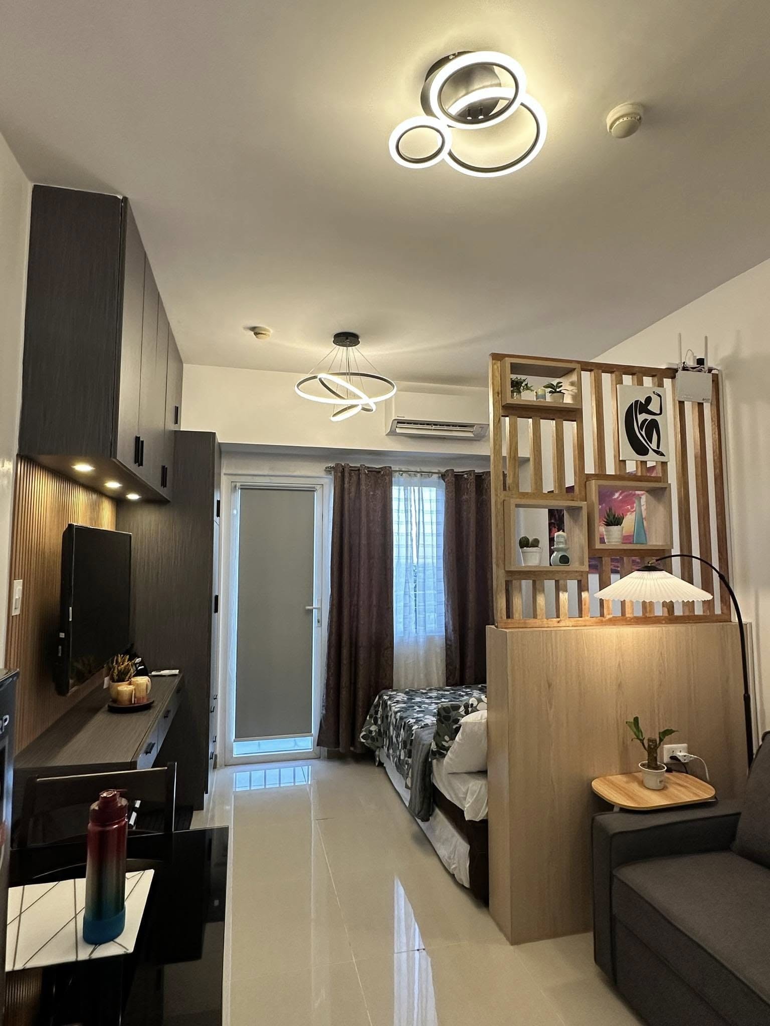 Full unit view — living area, bedroom, and divider